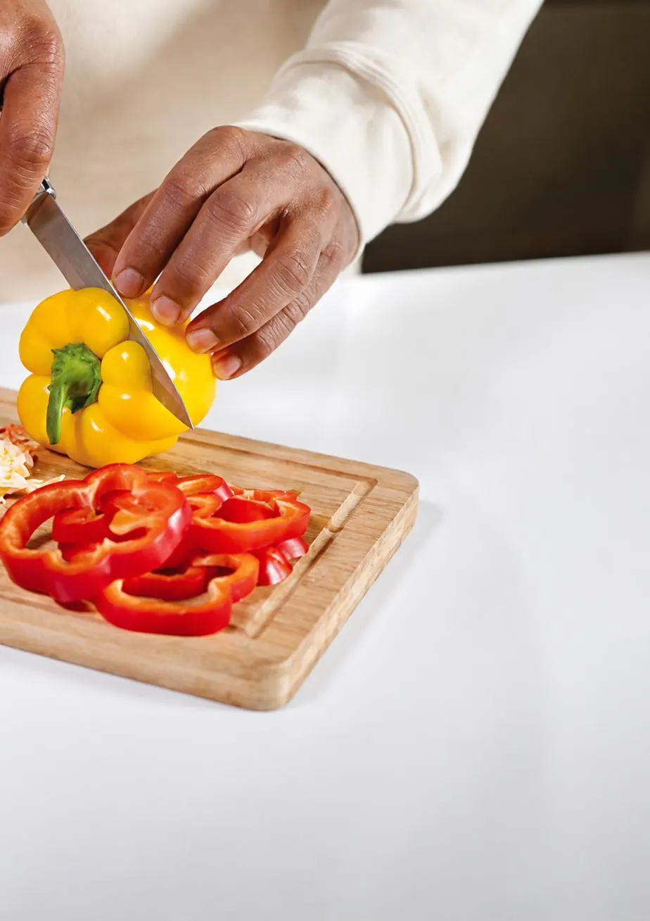 Peppers being sliced on a worktop: the trimmings of everyday cooking.