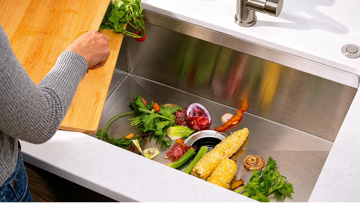 The sink of a modern kitchen with vegetable leftovers, before grinding.